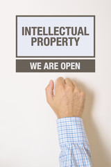 Businessman knocking on Intellectual Property Office door