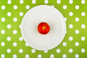 Eating raw red tomato, top view