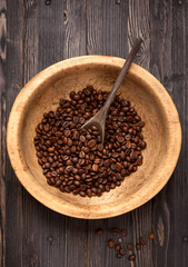 Roasted beans coffee in old vintage wooden bowl