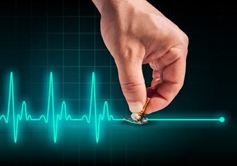 Hand putting out cigarette on heart beat line