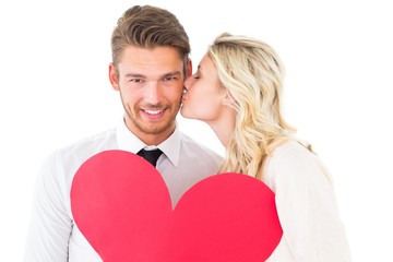 Attractive young couple holding red heart