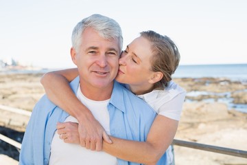 Casual couple having fun by the sea