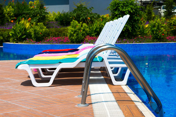 Obraz na płótnie Canvas Sun chairs at the pool