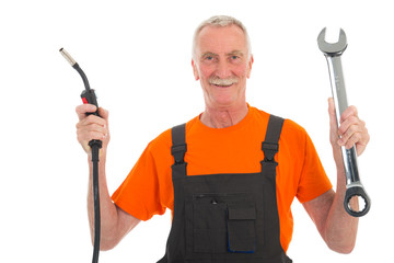 Happy man in orange and gray overall with wrench
