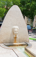 Fountain carved as a female face in Nimes, France