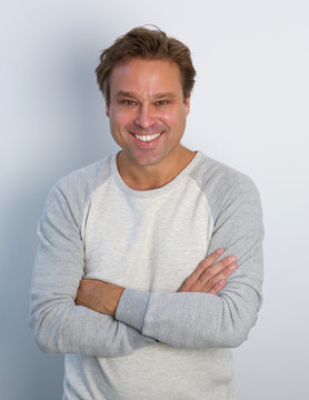 Mature man smiling with arms crossed