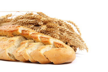 Bread and wheat ears on white background.