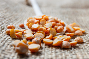  dry peas on a wooden spoon, close up