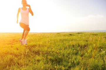 Runner athlete  running on sunset grass seaside