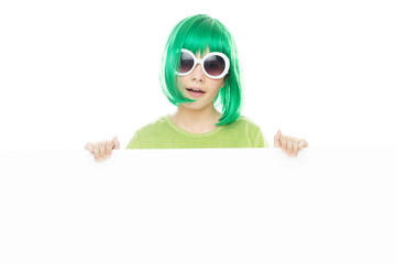 Cute young girl in a green wig holding a sign