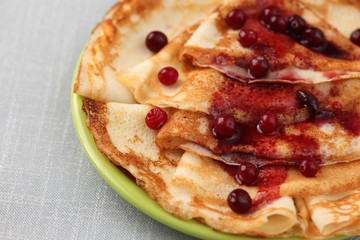 Pancakes (Blini) with cranberry on a plate