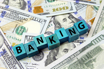 word banking on wooden cubes on american dollars background