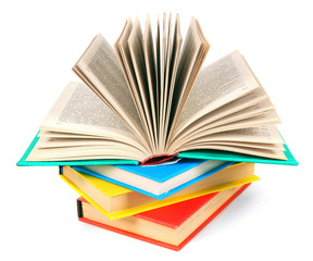 The open book on a pile of multi-coloured books.