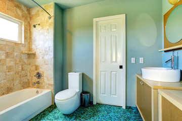 Fototapeta na wymiar Bathroom interior in light blue with tile wall trim