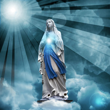 Madonna statue with blue sky and clouds background