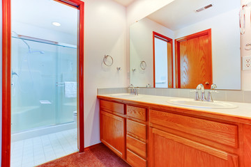 Bright bathroom with glass door shower and vanity cabinet