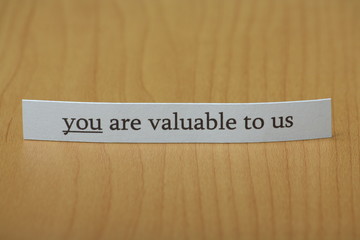 You are valuable to us typed on a strip of paper