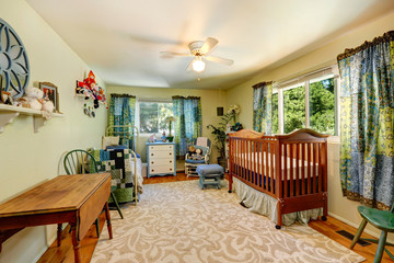 Nursery room with crib and old bed