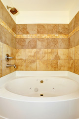 Bathroom with tile wall trim and white bath tub