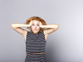 Surprised young girl in stylish dress