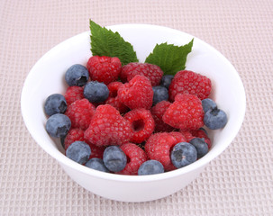 fresh raspberries and berry on a bowl
