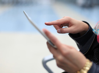 Digital tablet computer with isolated screen in woman hands