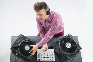 Top view portrait of dj mixing and spinning turntable