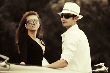 Young fashion couple at the classic car