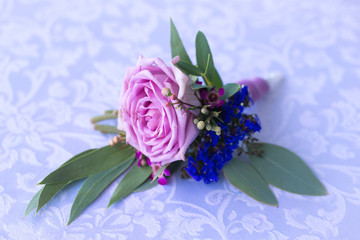 Purple rose boutonniere for the groom. Vintage