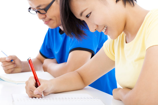 two young students studying together in classroom