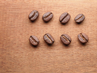 Coffee crop beans on wood texture