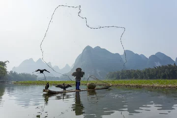Keuken spatwand met foto Cormorant, fish man and Li River scenery sight with fog in sprin © cchfoto