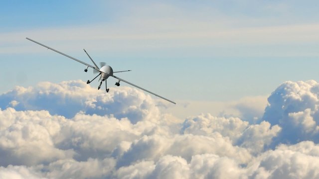 an armed predator drone in flight on the camera