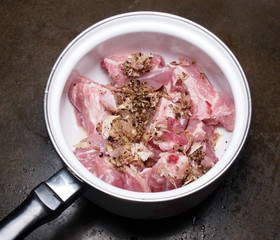 Raw pork meat with garlic pepper and shell sauce in pot before c