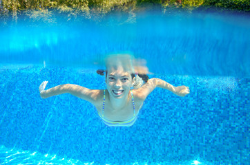 Child swims in swimming pool, underwater and above view