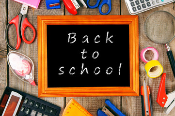Frame and school tools. Vertically. Wooden background.
