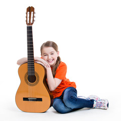 Cute girl sitting with acoustic guitar.