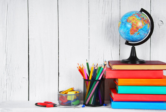 Books and school tools on a wooden shelf. - Powered by Adobe