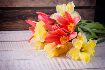 Postcard with fresh flowers tulips and daffodils