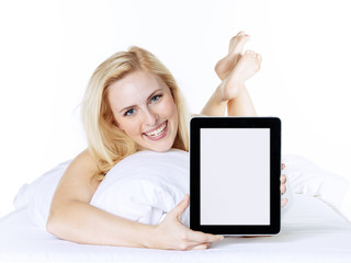 Woman in bed presenting her tablet with copyspace