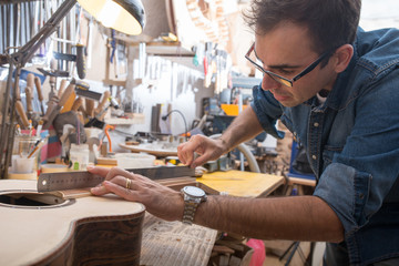 One luthier working on his next guitar - obrazy, fototapety, plakaty