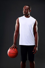 Portrait of African American man holding basketball ball