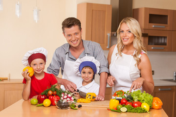 Young father teaching son how to prepare salad.