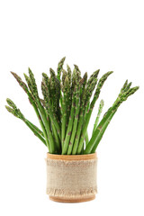 Fresh green asparagus in wooden pot.