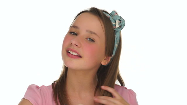 Pretty young girl playing with her brown hair