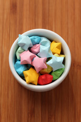 Colorful origami lucky stars in a bowl