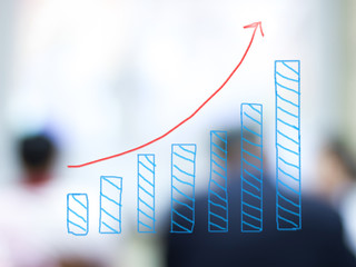 growth bar chart with blurred business people background