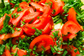 Sliced tomatoes background with green onions