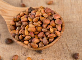 pine nuts on wooden surface