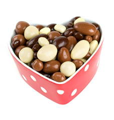 chocolate covered nuts and raisins in a heart-shaped bowl